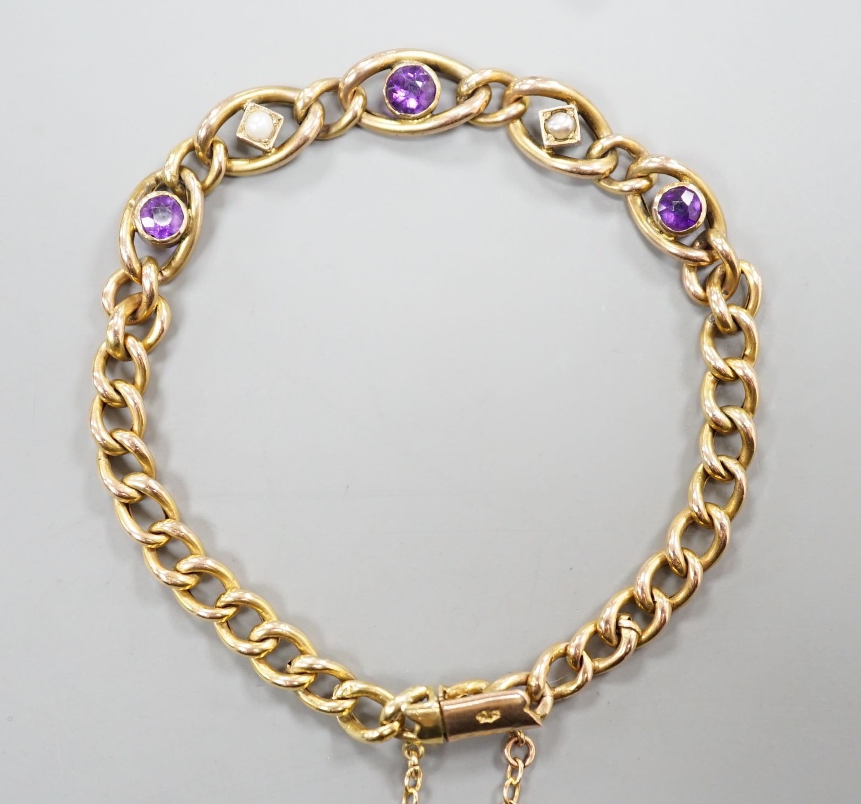 An Edwardian 9ct, amethyst and seed pearl set bracelet, 18cm, 6.1 grams.